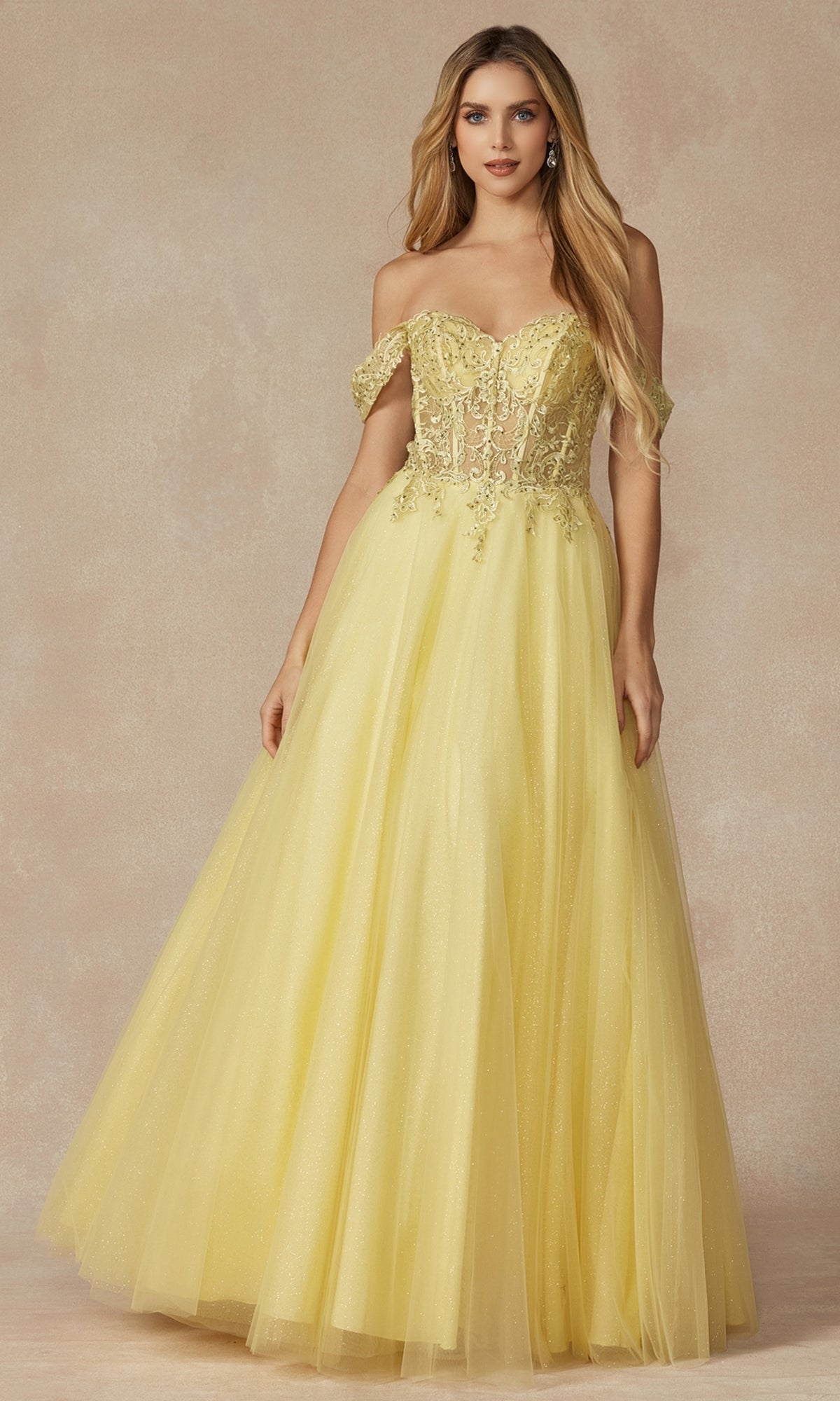 A woman models the Lace-Up Off-Shoulder Long A-Line Prom Dress 280, featuring a floor-length yellow tulle skirt and a sheer embroidered lace corset bodice, set against a neutral background.